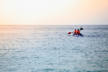 Fototapeta na wymiar Two men are paddling A happy kayak in the sea In Krabi Province, Thailand