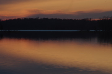 Fototapeta na wymiar sunset orange and fiery with reflection in lake