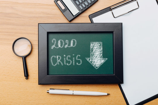 charts of economics and stock markets on a chalk board. financial crisis concept.