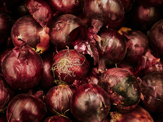 close up of red onion, onions at farmer's market as background