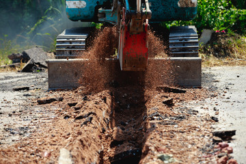 Fototapeta na wymiar Backhoe is digging road to lay water pipe.
