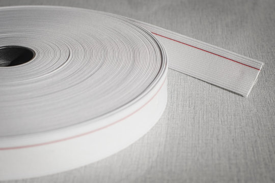 White elastic band roll for sewing close-up.