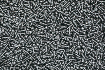A lot of taping metal or iron screws, screws as a background, wallpaper or texture, industrial background and concept