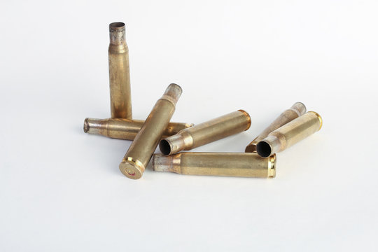 rifle bullet shell casings on white background
