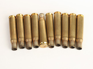 rifle bullet shell casings on white background