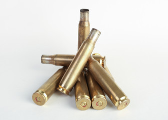 rifle bullet shell casings on white background