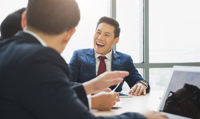 Asian business people team analyzing statistics financial. Team of businesspeople Meeting Conference Discussion Corporate Concept in office.