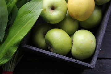Healthy nutrition, apples and green leaves.