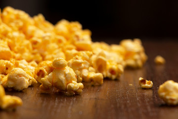 close up of popcorn on a dark brown table