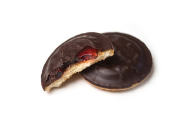 Closeup of crunched chocolate cakes with jam on white background
