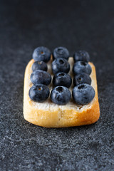 Toast with fresh blueberry and greece cheese close up