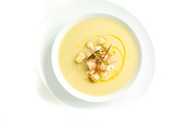 Yellow vegetable soup with croutons