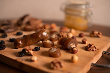 churchhella candy East healthy candies on a wooden Board on the brown wooden table with nuts,f and raisins