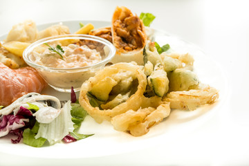 Plate of fried seafood with spicy sauce