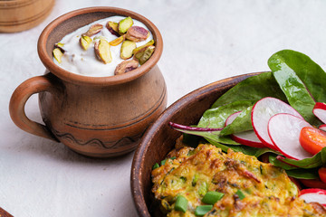 Zucchini fritters with green salad and Greek yogurt dipping sauce