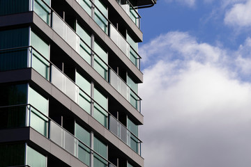 Facade of the house with balconies. Blue sky background. Vacation concept