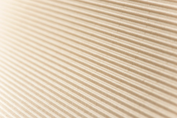 Carton or cardboard packing material. Texture of corrugated paper sheets made from cellulose. Supplies for creating boxes and packaging. Pasteboard background. Natural brown cardboard surface.