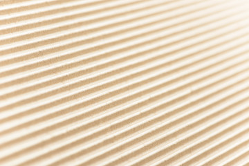 Carton or cardboard packing material. Texture of corrugated paper sheets made from cellulose. Supplies for creating boxes and packaging. Pasteboard background. Natural brown cardboard surface.