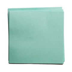 A few notes or a blue-green cube on a white background.