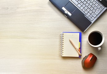 Black coffee cup, mouse,laptop,notebook and pen,with copy space on white wooden table,stay home ,work at home concept 