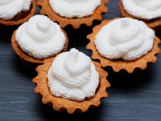 Cake with protein cream is not a black background. Sandwich pastry baskets lined with a triangle.