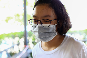 Portrait girl wearing medical mask to protect Coronavirus or Covid-19