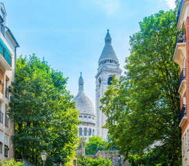 Sacre coeur cathedral under a blue sky in Montmartre neighborhood in Paris
