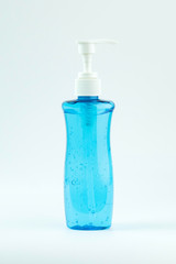 Blue pump head bottle of instant antiseptic hand sanitizer transparent gel isolated on white background, no label. Antibacterial, hydroalcoholic gel, ethyl alcohol.