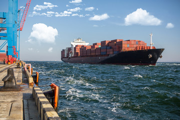 Container ship in port at container terminal. Ships of container ships stand in terminal of port on...