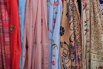 Multicolored fabric hanging on the clothesline for sale to customers