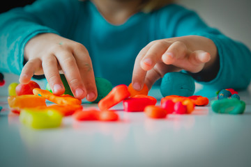 Child playing with clay molding shapes, kids crafts