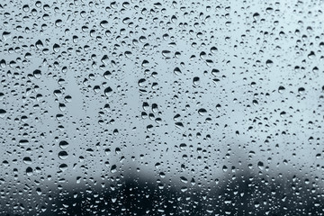 Naklejka na ściany i meble Window with raindrops in a stormy day
