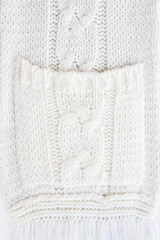 Fototapeta na wymiar Texture of knitted woolen fabric with knitted pocket as background