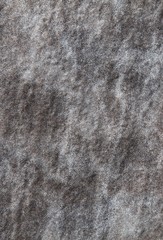 Wall surface made of volcanic stone, background. Dark rough wall texture with natural abstract pattern in white. Modern fashionable design for garden fences. Vertical frame