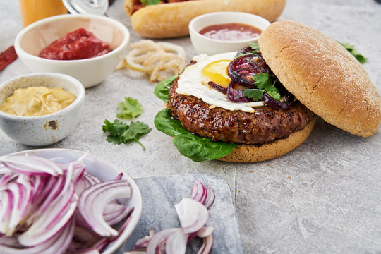 Close up of a hamburger with an egg and onions