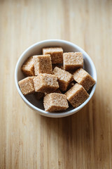 Close up photo of brown sugar bricks in a bowl, stylish food photo