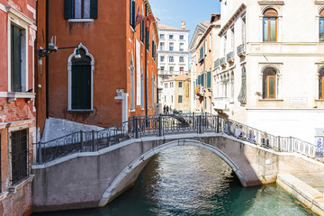 Water channels of Venice city. Facades of residential buildings overlooking the small canal and Ponte de S. Paternian bridge in Venice, Italy.