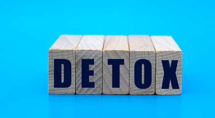 concept word DETOX on cubes on a blue background