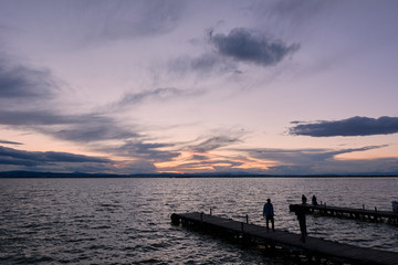 Jetty on a lake a stormy day, sunset