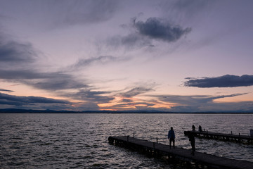 Fototapeta na wymiar Jetty on a lake a stormy day, sunset