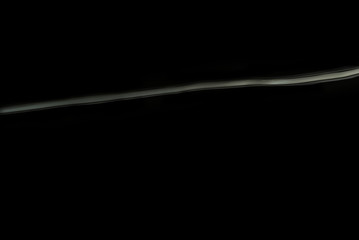 Bright white line of water ripple with black background