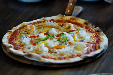 seafood pizza in the wooden tray