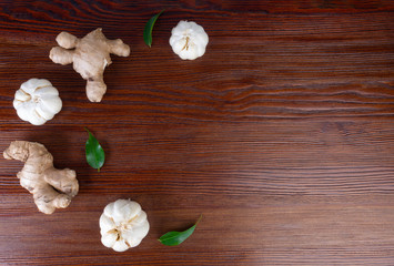 ginger and garlic on wooden background