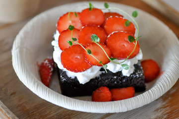 chocolate cake or brownie with strawberry topping