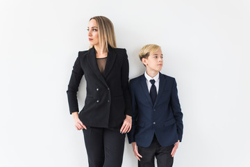 Teenager and single parent - Young mother and son standing together on white background.