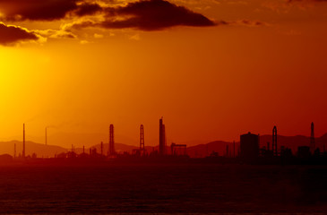 Fototapeta na wymiar sunrise in seabeach at industrial city in Japan