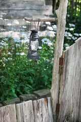 garden lantern by old rustic gate