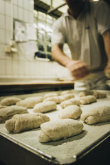 Baker who bakes pretzel sticks in a bakery