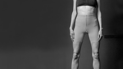 Fototapeta na wymiar A girl with anorexia, unrecognizable portrait, skinny legs, ribs, black and white