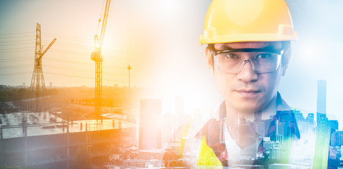 The double exposure image of the engineer holding a blueprints standing building site overlay with cityscape in sunrise.The concept of construction,smart city,engineering,architecture and future.
